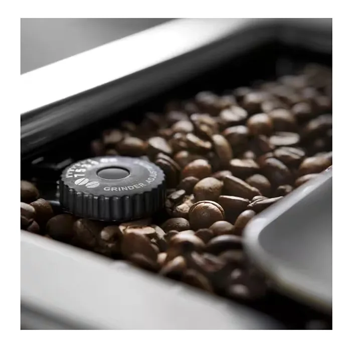 A view of the bean hopper and integrated conical burr grinder on the DeLonghi PrimaDonna Elite