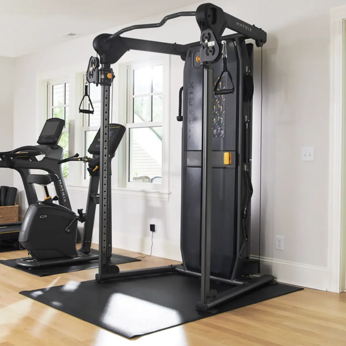 Home functional trainer with 25 height adjustments and centralized weight stack
