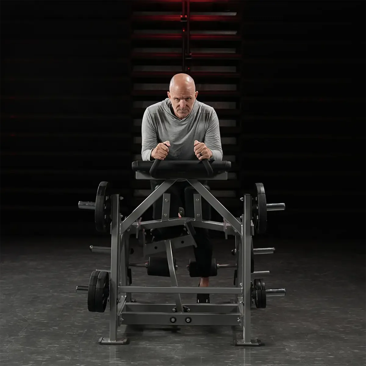 Hammer Strength hamstring curl machine with elbow pad and ergonomic handles