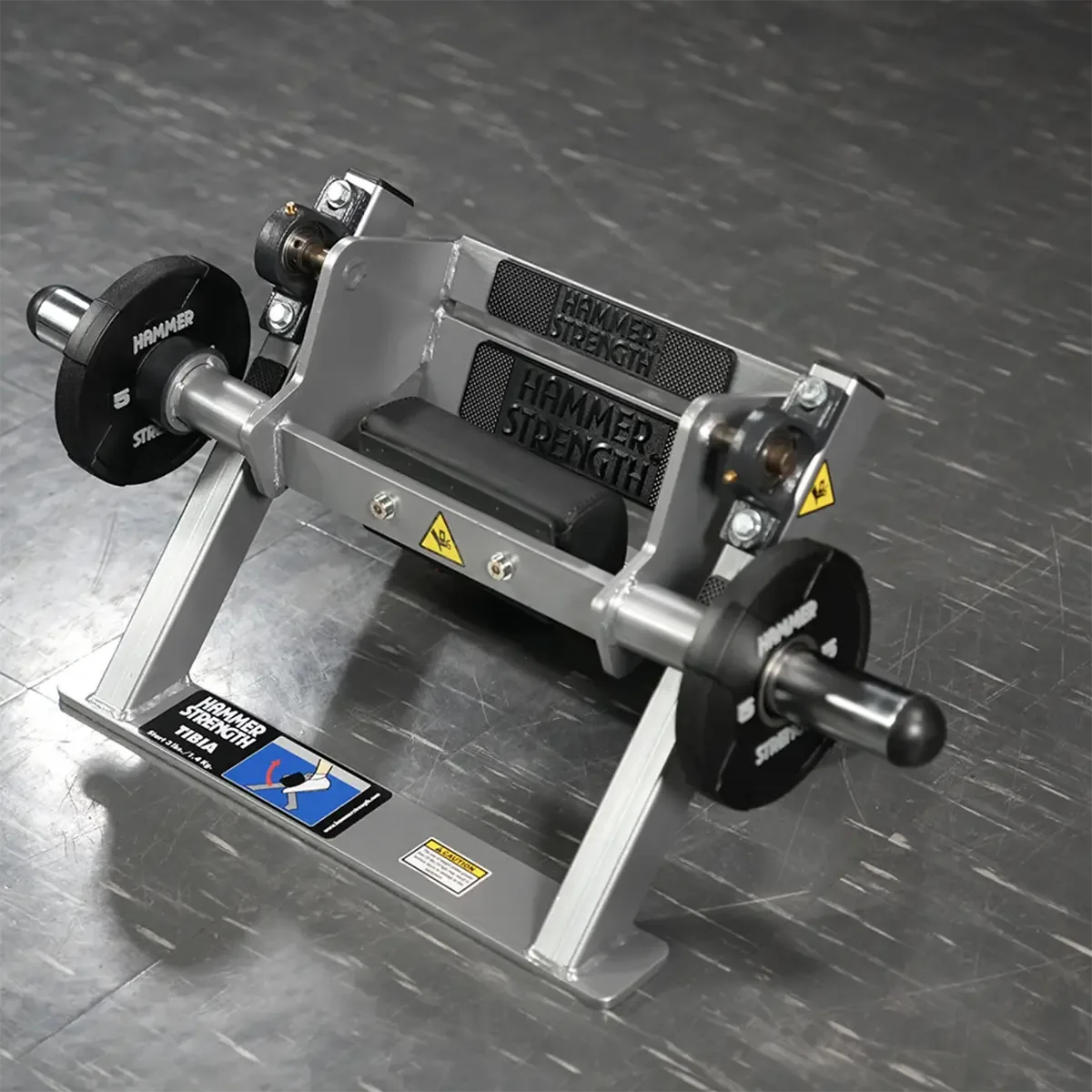 Lower leg strength machine with angled foot platform and dense upper foot pad
