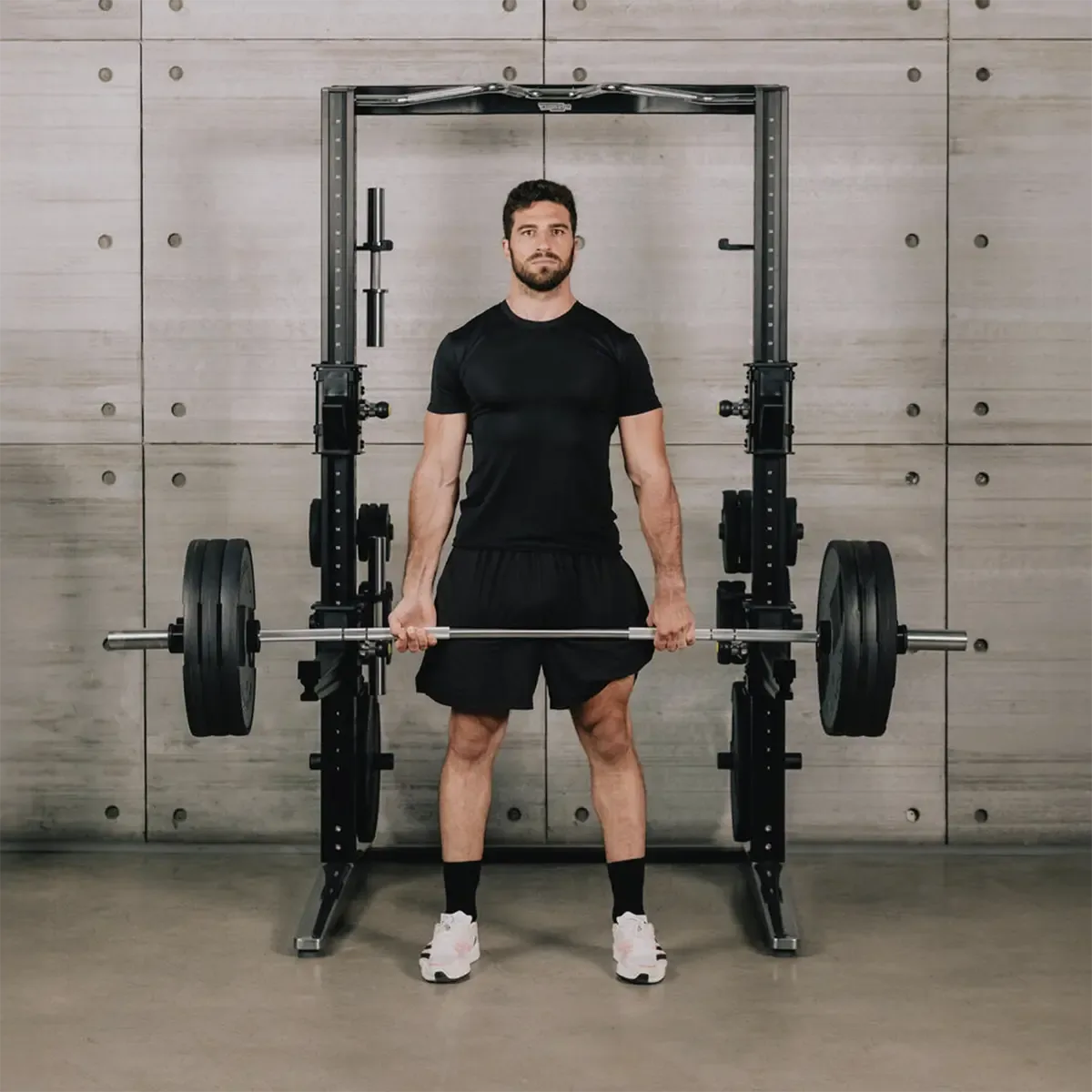 Technogym Personal Strength Home power rack bundle with barbell, dumbbell bars, plates, and clamps