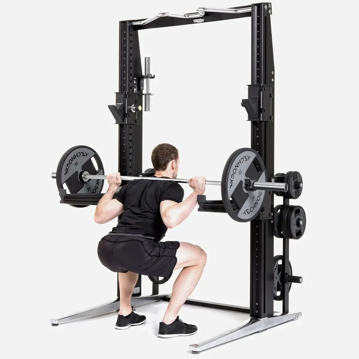 Technogym Personal Home power rack with barbell, dumbbell bars, and loadable plates