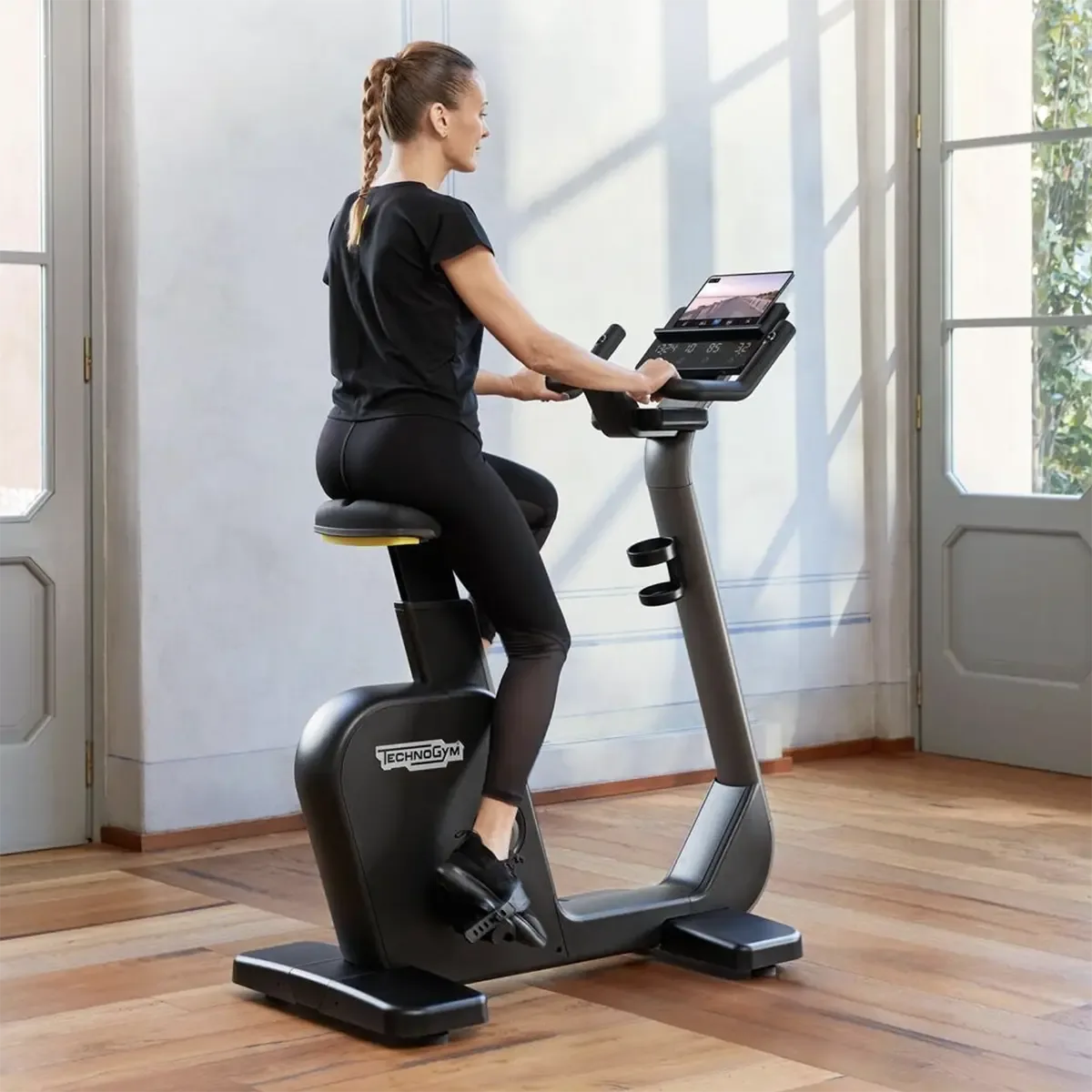 Cycle Compact exercise Side view of Technogym upright bike with easy-access design