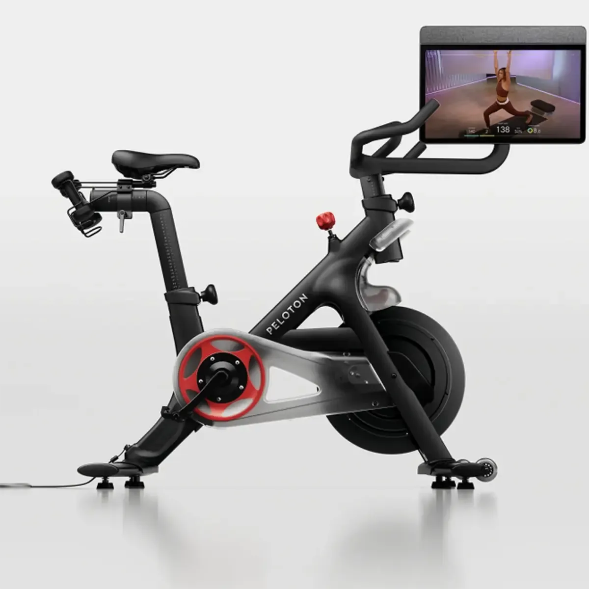 Peloton Home fitness bike with front-facing speakers and adjustable seat, handlebar, and screen