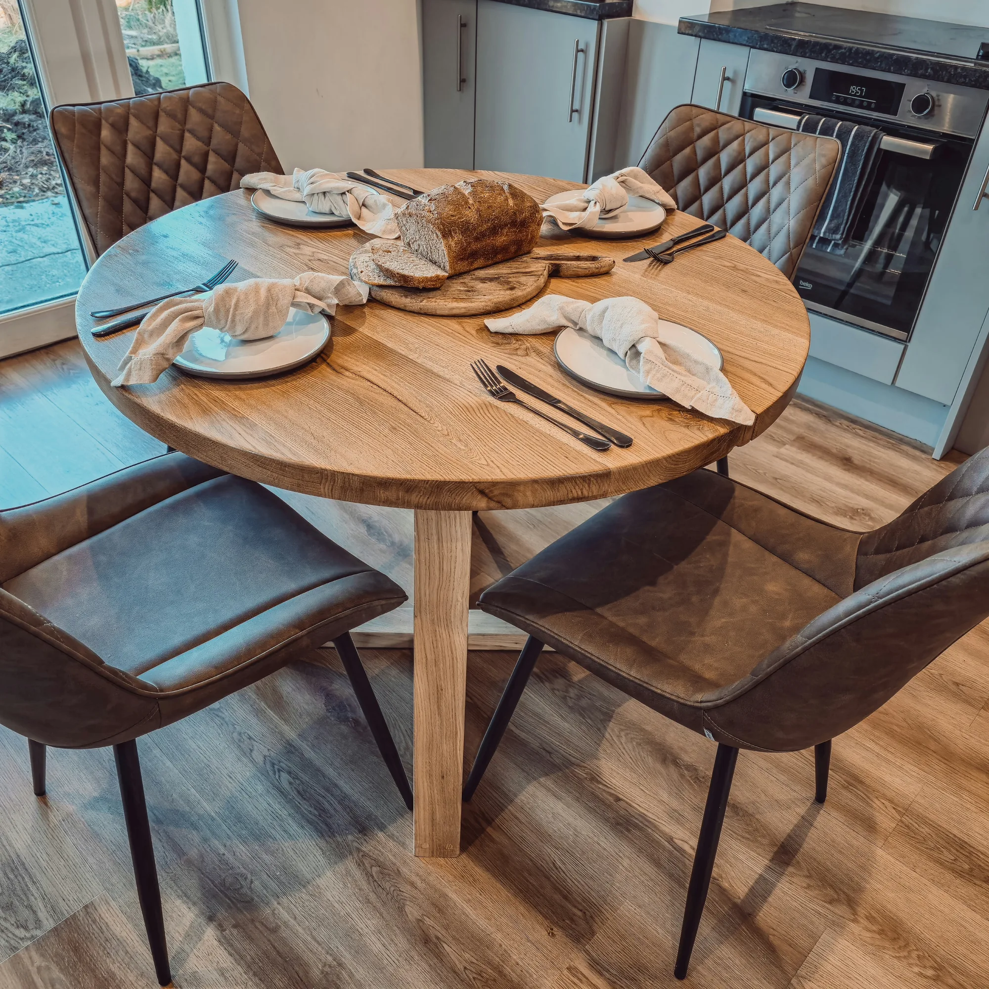 Solid Oak Round Dining Table With Wooden Legs and Leather Chairs