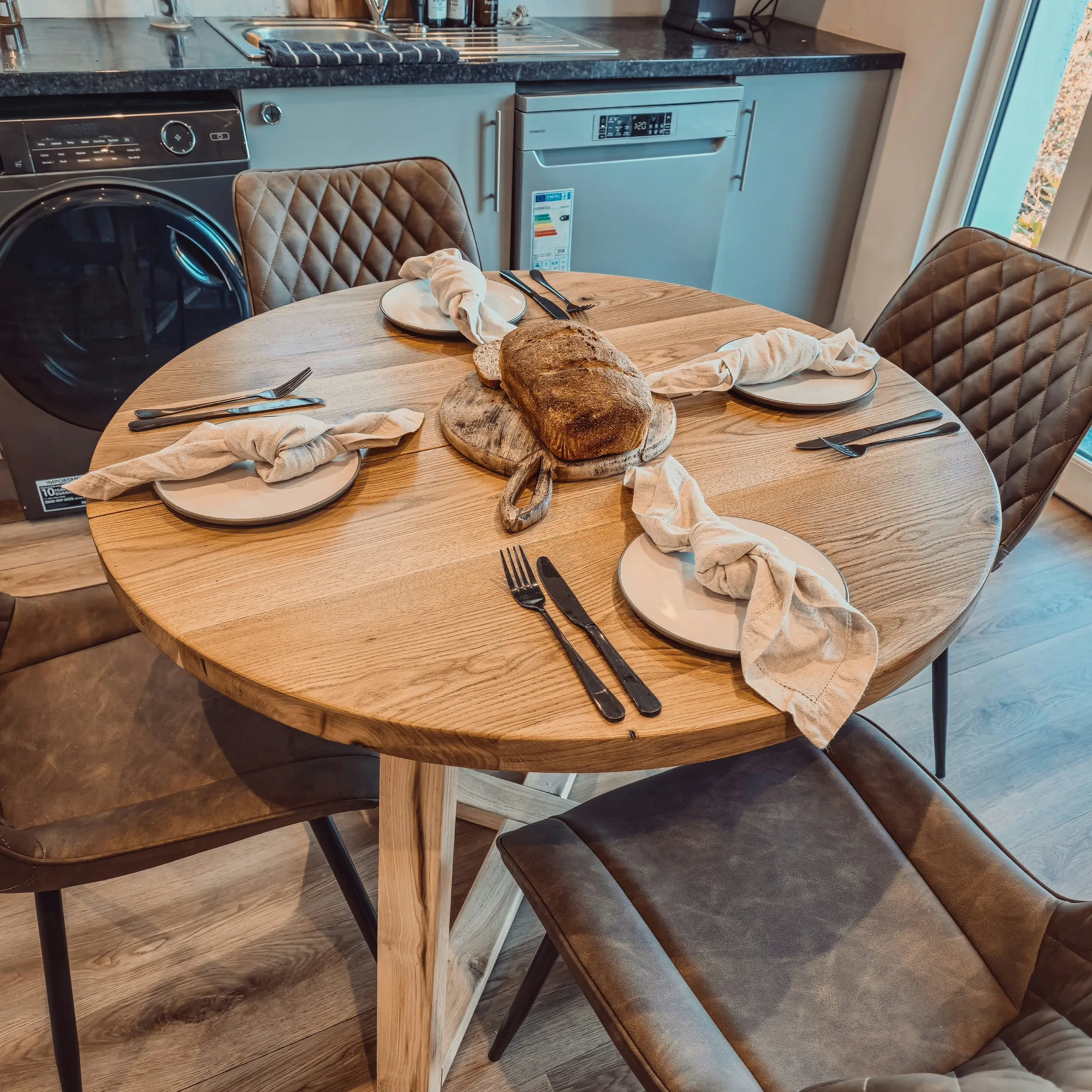 Solid Oak Round Dining Table With Wooden Legs and Leather Chairs